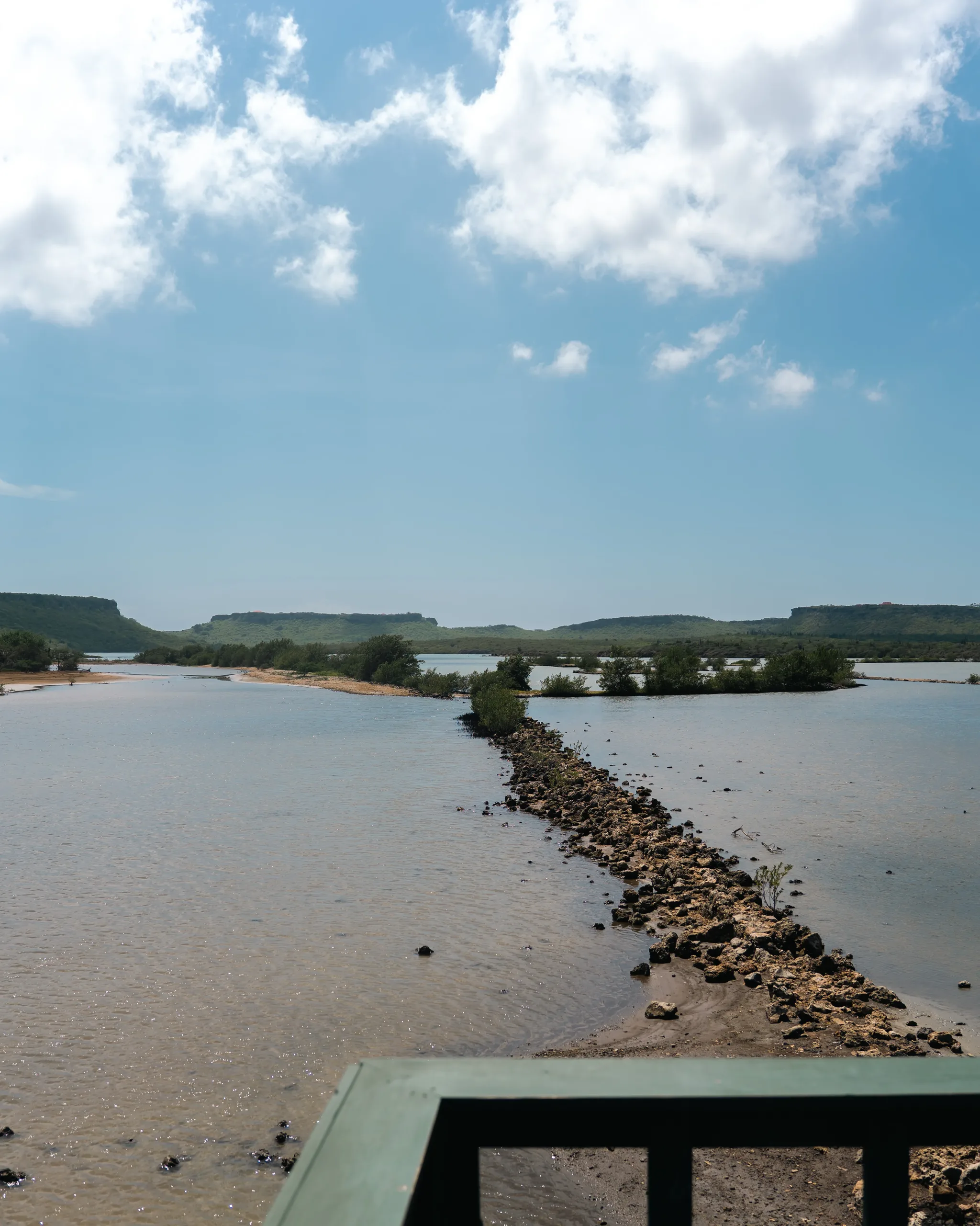 The salt-flat lagoon at Jan Kok seen from the viewing platform rail