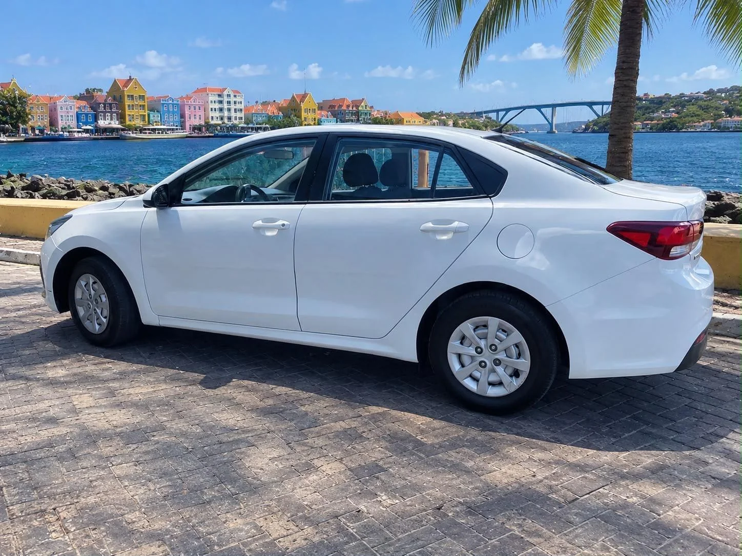 White Kia Rio sedan, side view