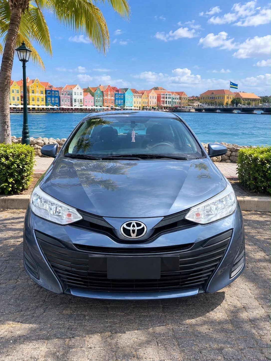 Blue-grey Toyota Yaris sedan, front view