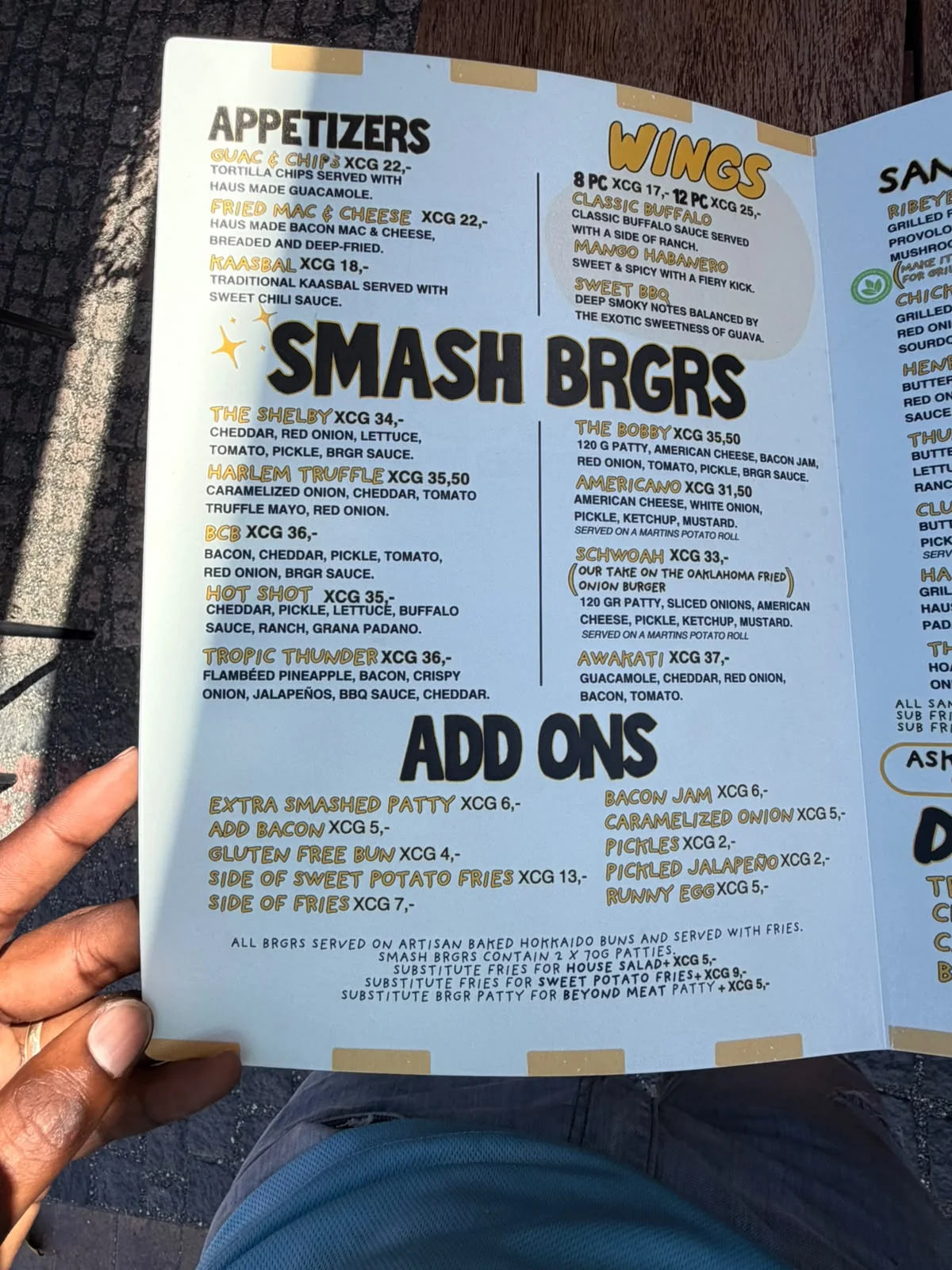 BRGR Haus menu page showing appetizers, wings, smash burgers and add-ons with prices in XCG.
